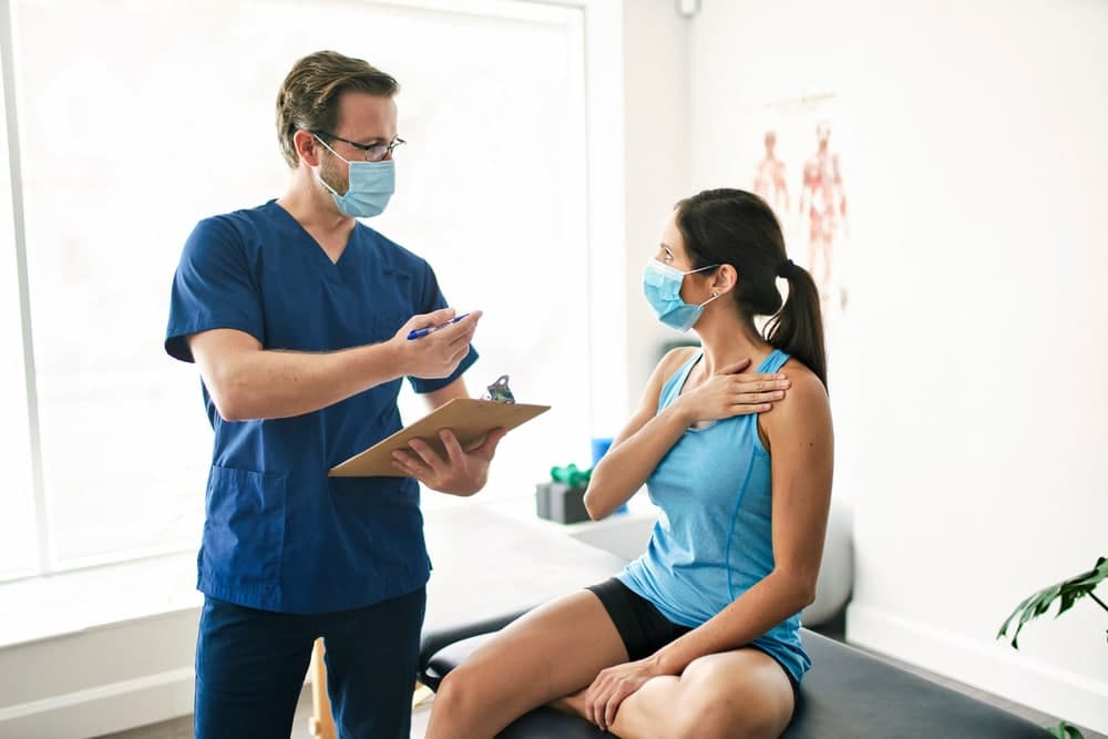 Therapist assisting a patient in a rehab clinic